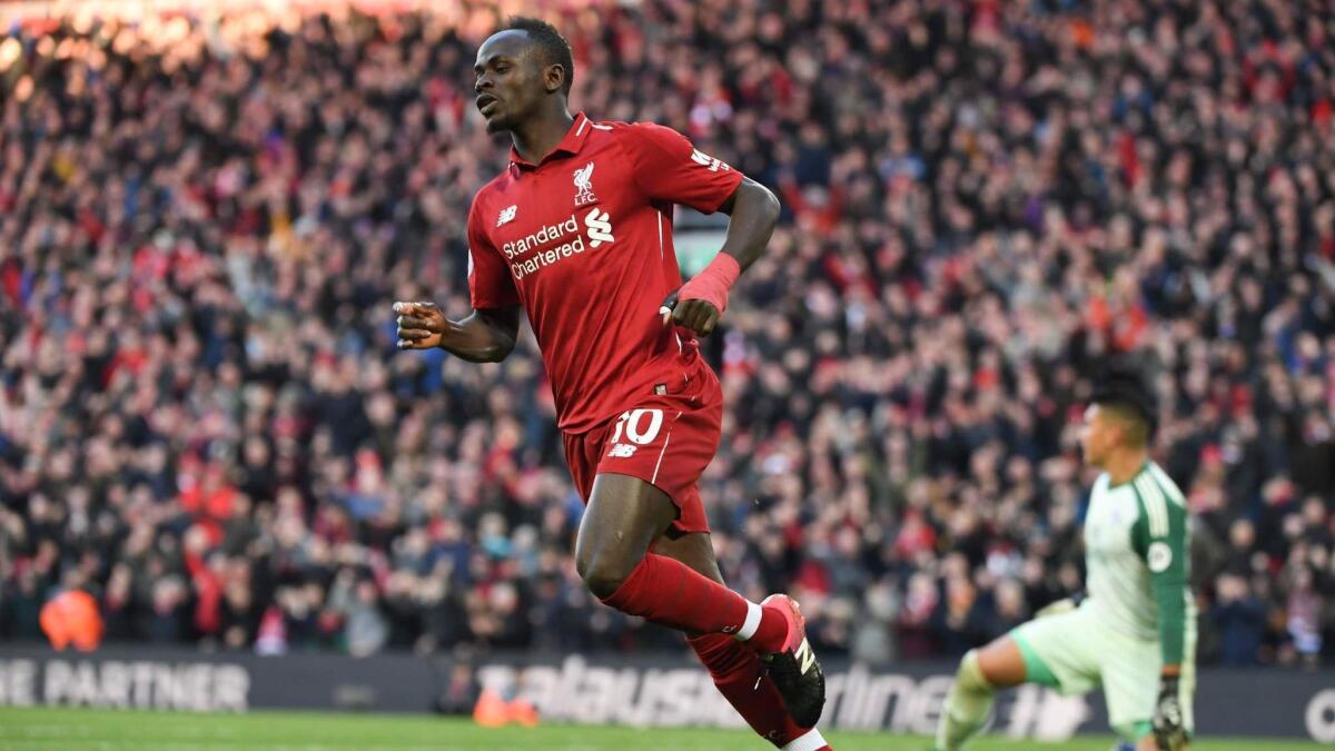 Liverpool striker Sadio Mane trots back to midfield after scoring a goal against Cardiff City last weekend.