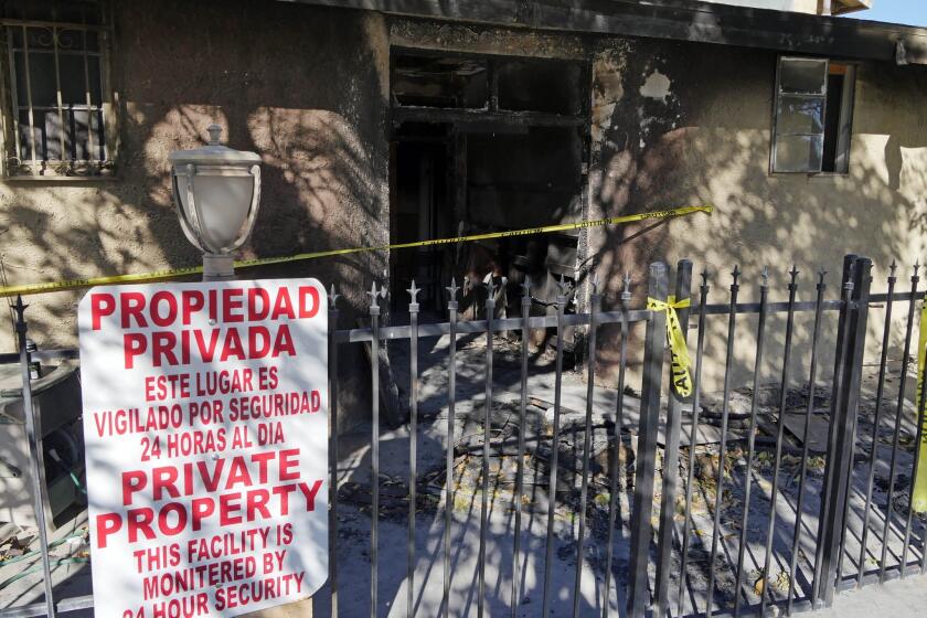 Police tape marks off the burned front lobby of the Islamic Center of Palm Springs in Coachella on Dec. 12.