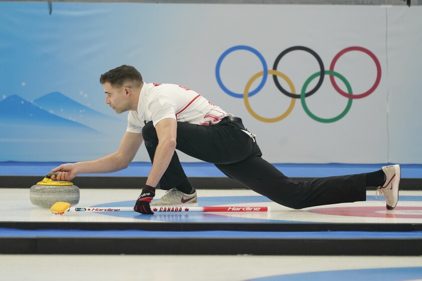 John Morris, of Canada, throws a rock during the mixed doubles curling match against Britain at the Beijing Winter Olympics Thursday, Feb. 3, 2022, in Beijing. (AP Photo/Brynn Anderson)