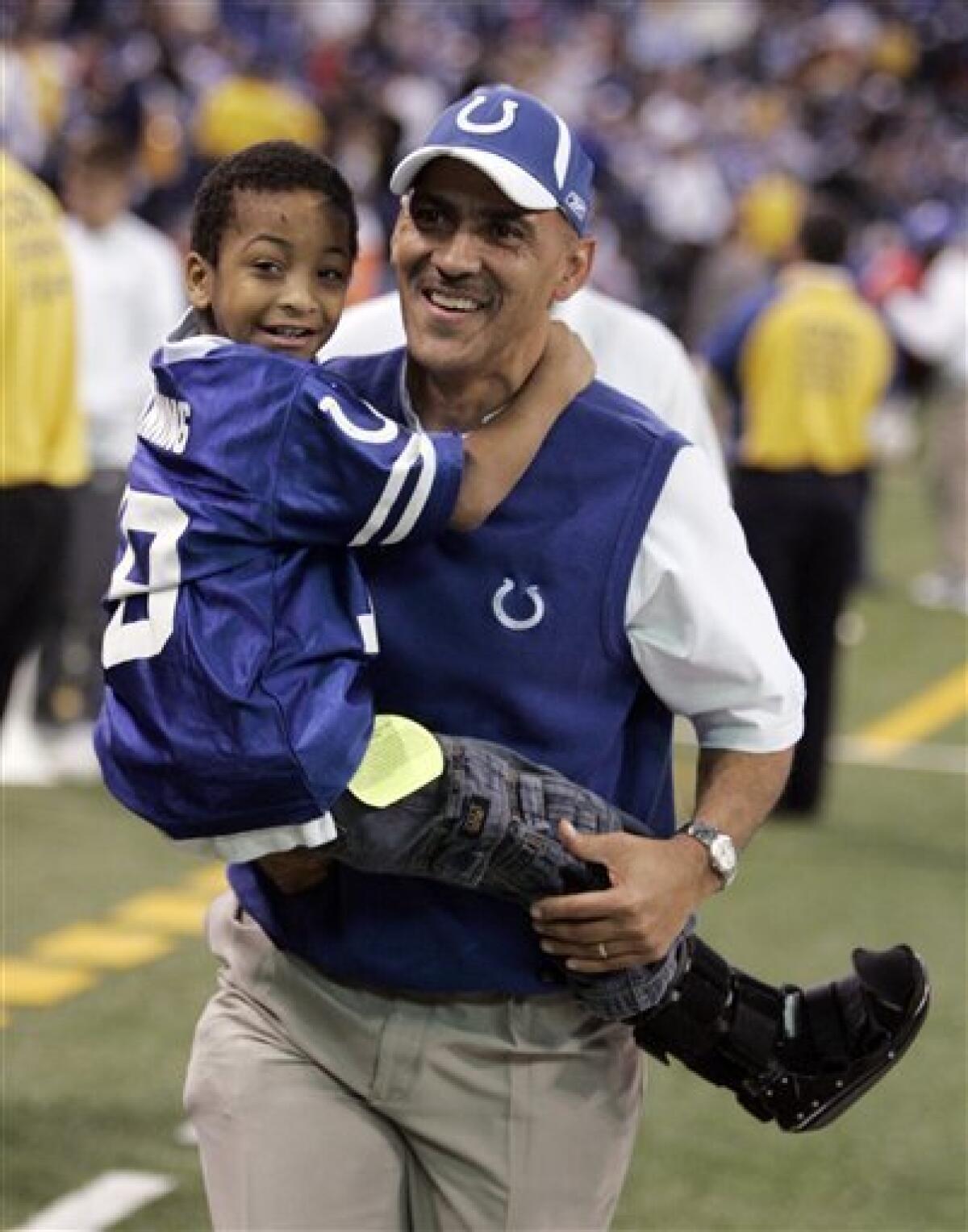 This Dec. 28, 2008 file photo shows Indianapolis Colts coach Tony Dungy carrying off his son, Jordan, after a Colts 23-0 win over the Tennessee Titans in a NFL football game in Indianapolis. Dungy is retiring after seven years as coach of the Indianapolis Colts, according to reports Monday Jan. 12, 2009. (AP Photo/Michael Conroy, File)