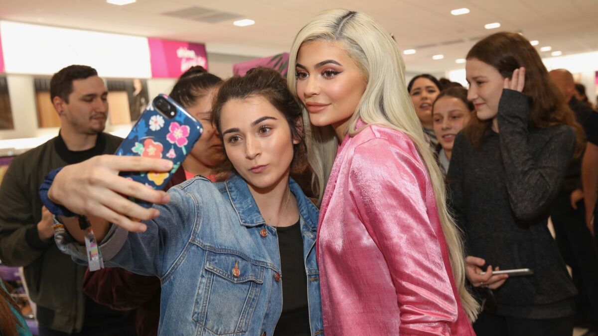 Kylie Jenner, right, visits an Ulta Beauty store in Houston on Nov. 18 to promote her cosmetics line.