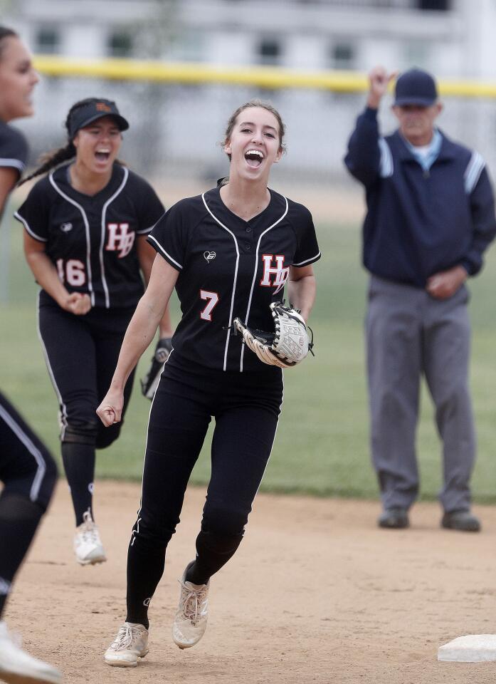 Huntington Beach's first baseman Mikayla Carman and Huntington Beach's Megan Ryono celebrate victory after the final out of the game being signaled by the first base umpire in a CIF Southern Section Division 1 quarterfinal girls' softball playoff at Chino Hills High School in Chino Hills on Thursday, May 9, 2019. Huntington Beach won the game 3-1.