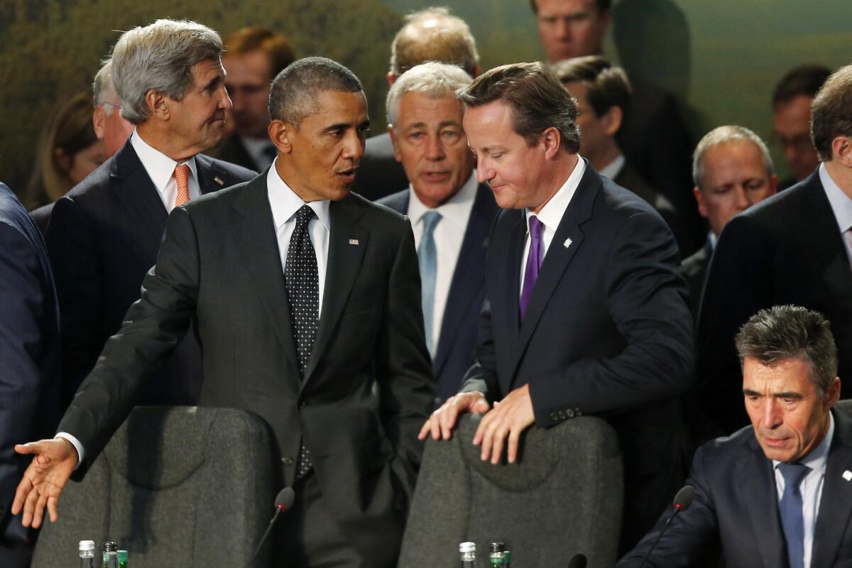 President Obama speaks with British Prime Minister David Cameron as NATO leaders meet in Newport, Wales, on Sept. 4.