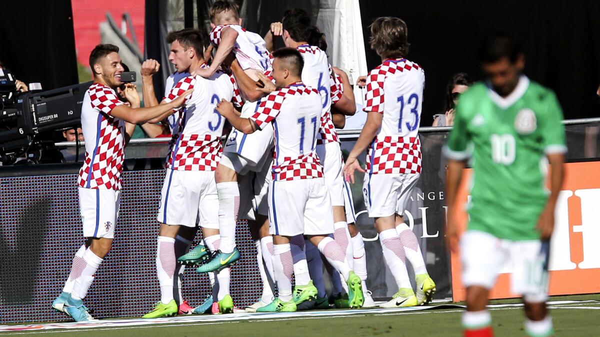 Croatia players celebrate a goal against Mexico during the first half Saturday.