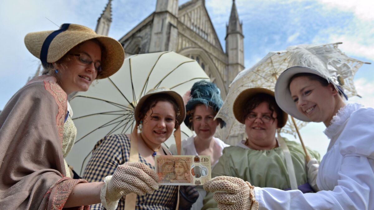 Fans in Regency-era dress with the new Jane Austen bank note.
