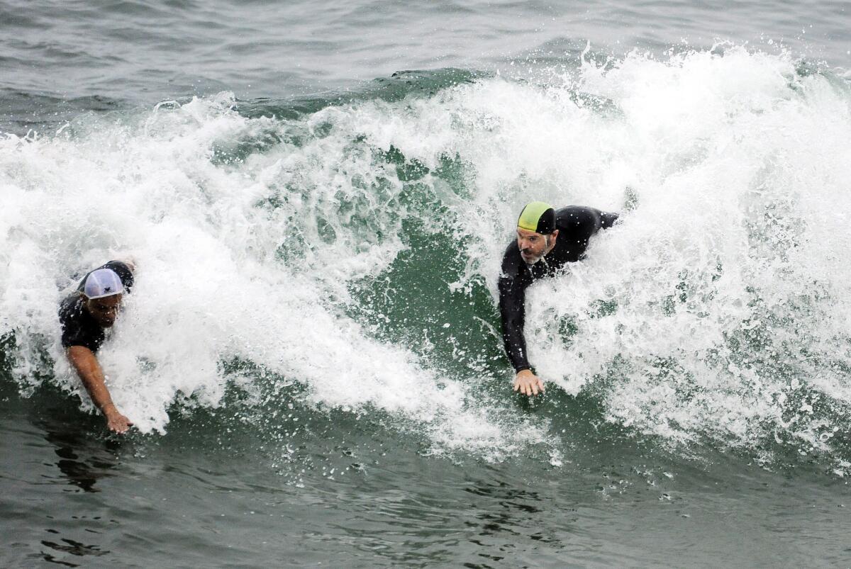 Participants compete in the Masters' preliminary heats during the International Bodysurfing Championships off the Manhattan Beach pier on Aug. 6.