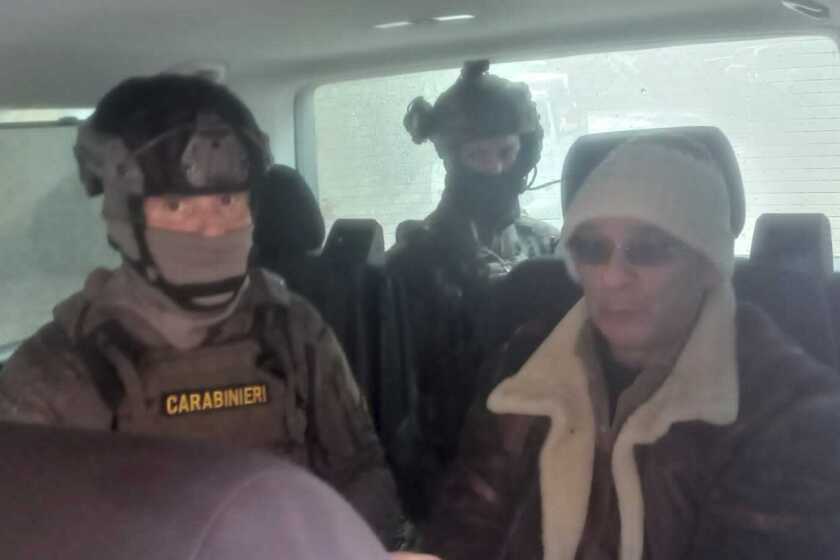 In this Italian Carabinieri handout photo made available on Monday, Jan. 16, 2023, top Mafia boss Matteo Messina Denaro, right, is seen in a car with Italian Carabinieri officers soon after his arrest at a private clinic in Palermo, Sicily, after 30 years on the run, Monday, Jan. 16, 2023. (Carabinieri via AP)