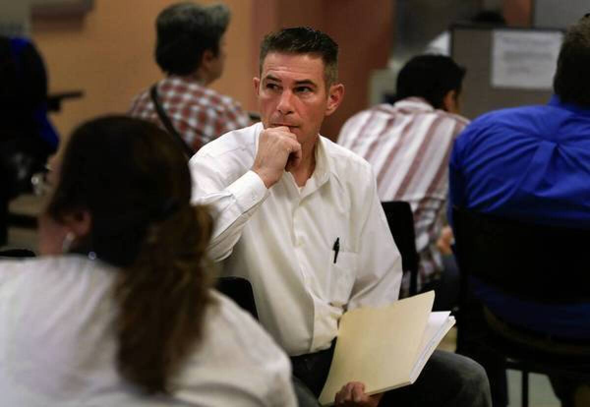 David Lightfoot waits to speak to a representative at the state Employment Development Department, via telephone, at the Verdugo Jobs Center in Glendale.