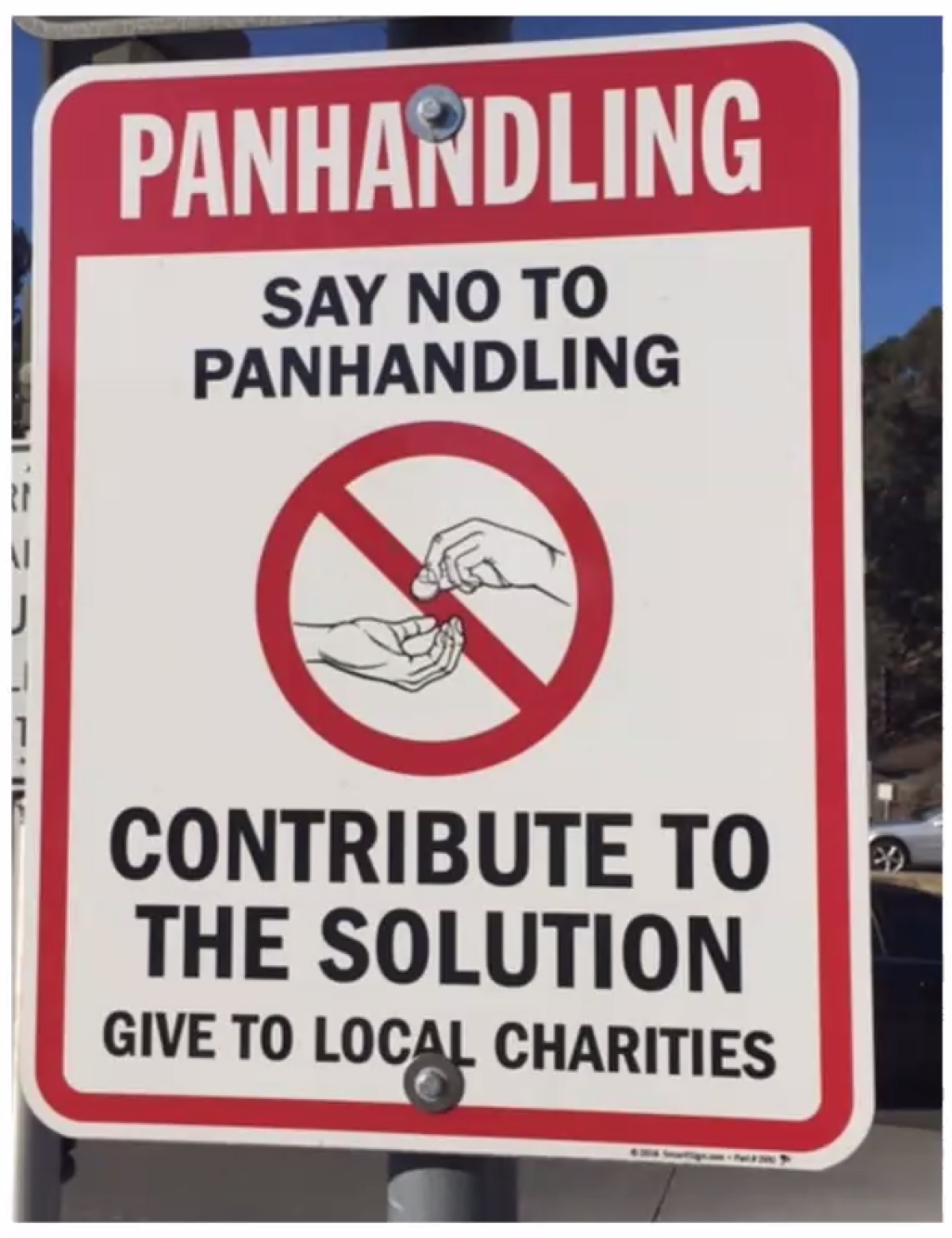 Chris Cott presented this sign as an example of what he'd like placed in some road medians to discourage panhandling.