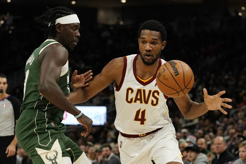 Cleveland Cavaliers' Evan Mobley loses the ball in front of Milwaukee Bucks' Jrue Holiday during the first half of an NBA basketball game Monday, Dec. 6, 2021, in Milwaukee. (AP Photo/Morry Gash)