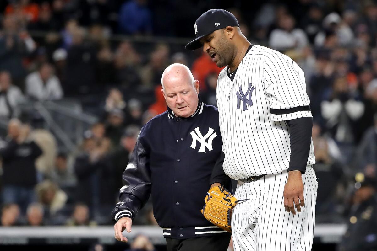 Yankees pitcher CC Sabathia walks off the field.