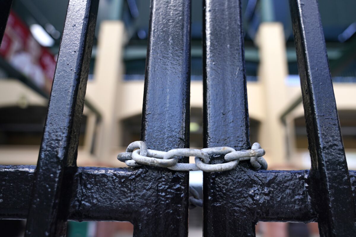 The gate to Roger Dean Stadium in Jupiter, Fla., is locked for spring training.