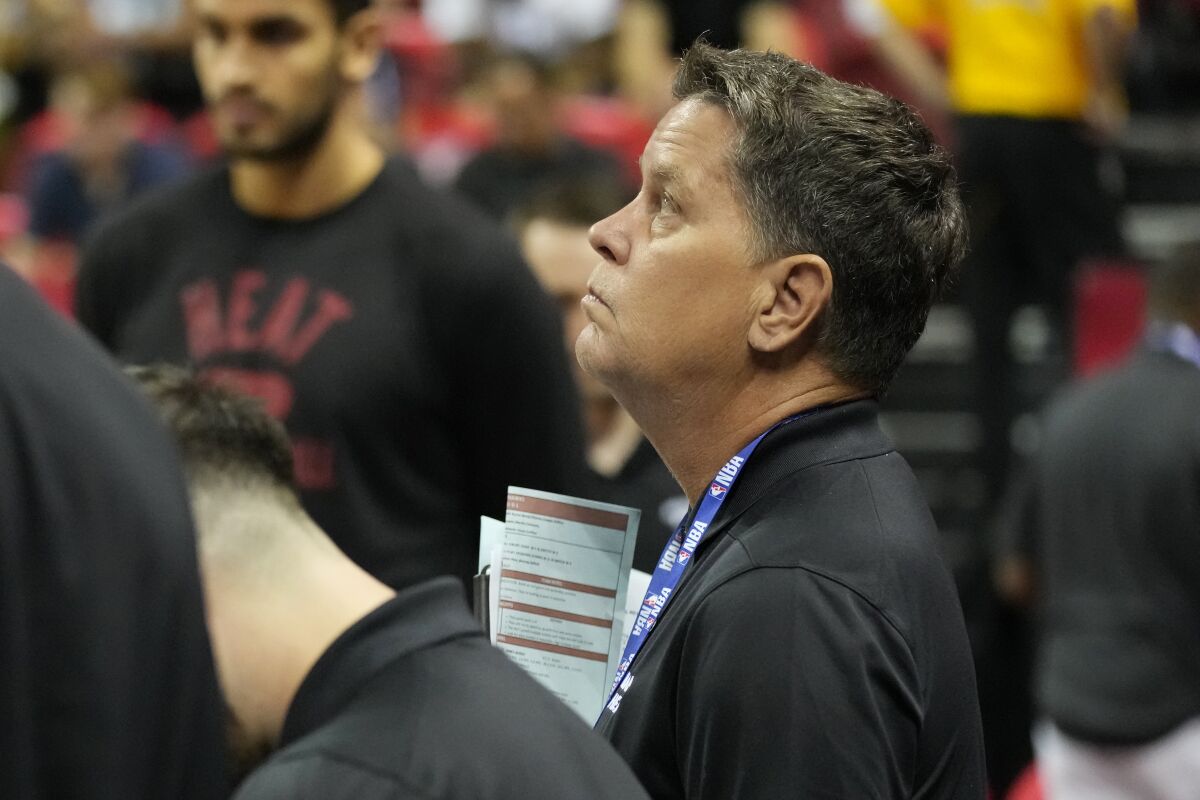 Miami Heat assistant Tim Cone, right, watches during the first half an NBA summer league basketball game against the Atlanta Hawks, Tuesday, July 12, 2022, in Las Vegas. (AP Photo/John Locher)