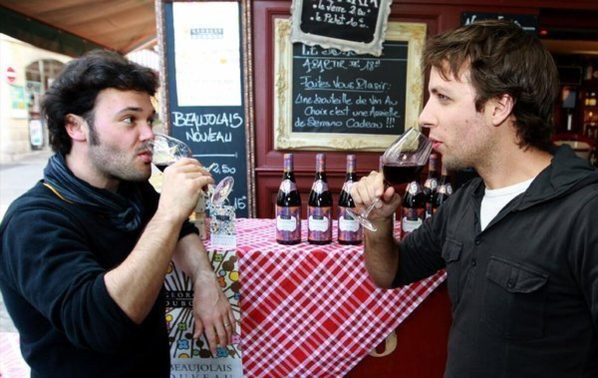 Customers at a wine shop in Bayonne, France, enjoy the first glasses of Beaujolais Nouveau.