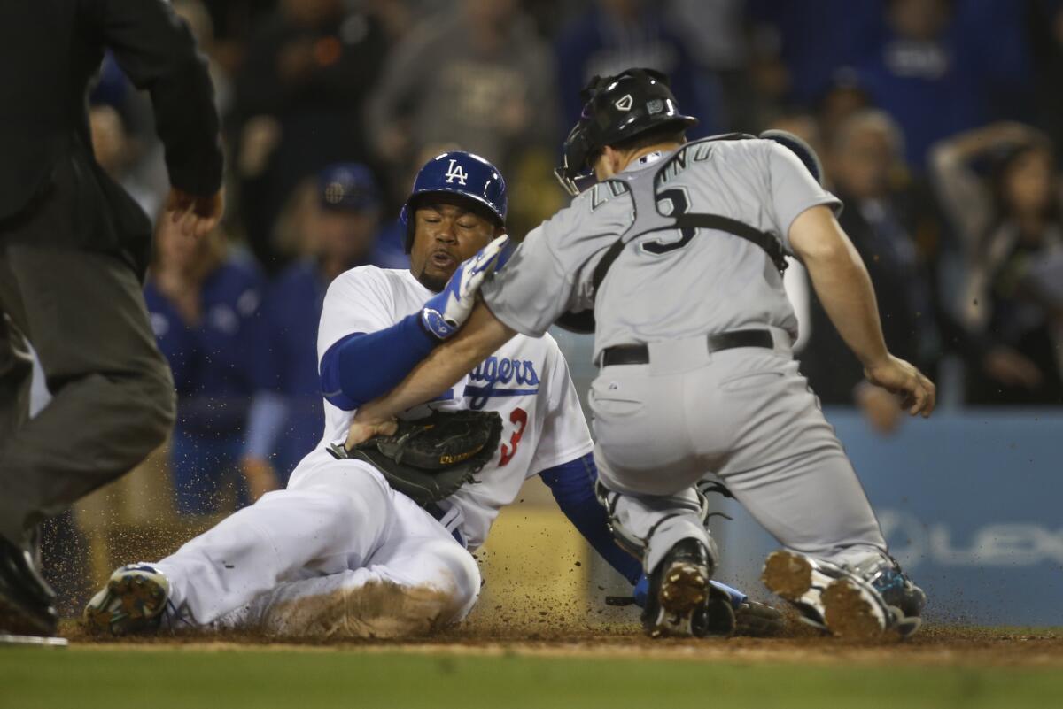 Carl Crawford beats the throw to Seattle catcher Mike Zunino to score the game-winning run for the Dodgers on a two-run single by Howie Kendrick. The Dodgers beat the Mariners, 6-5.