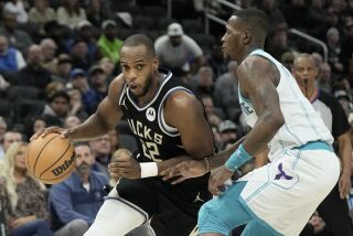 Milwaukee Bucks' Khris Middleton drives past Charlotte Hornets' Terry Rozier during the second half of an NBA basketball game Tuesday, Jan. 31, 2023, in Milwaukee. The Bucks won 124-115. (AP Photo/Morry Gash)