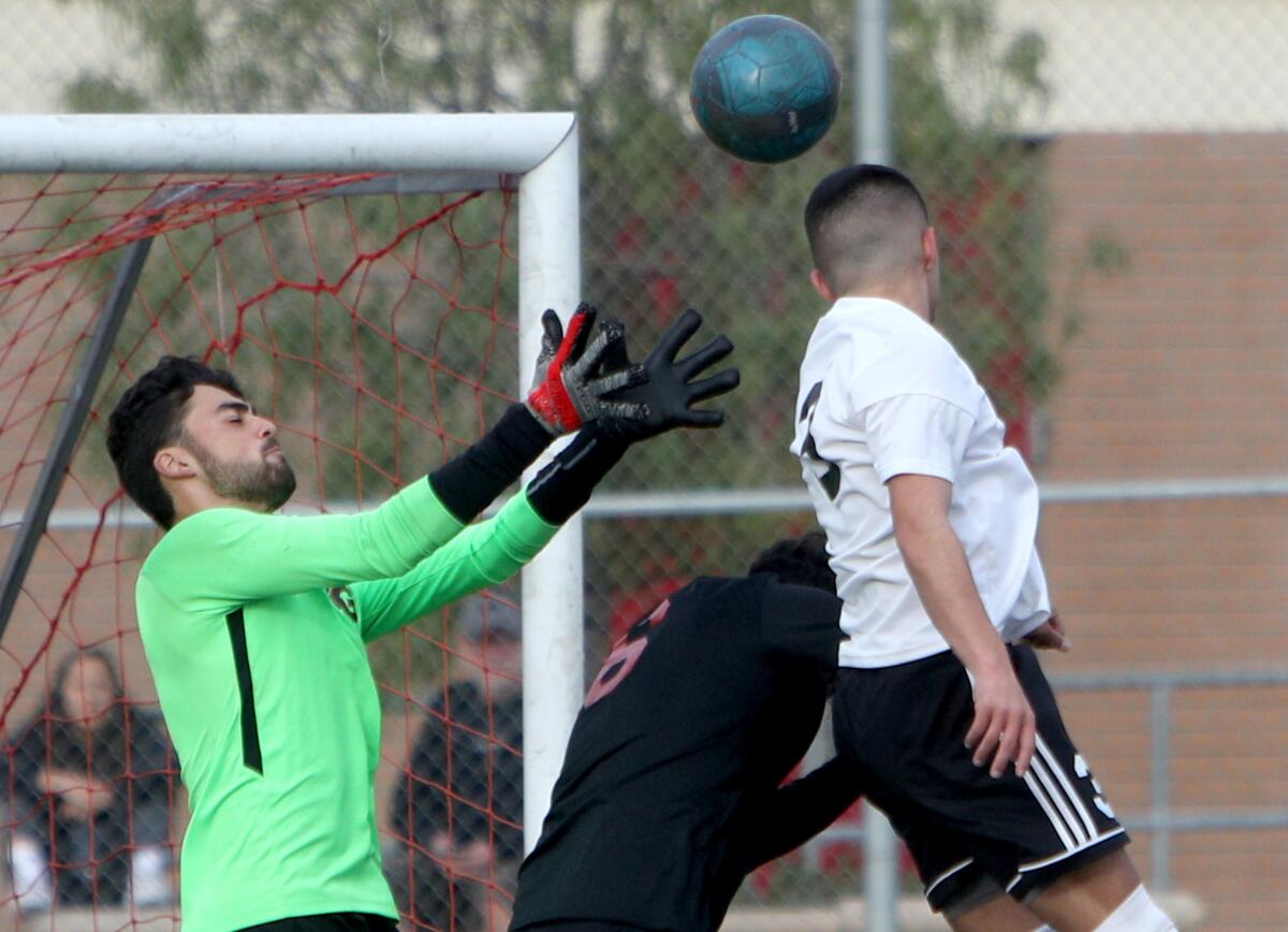 Burroughs High School soccer player Manny Gonzalez scores on a header in game vs. Glendale High in Glendale on Tuesday, Jan. 21, 2020.