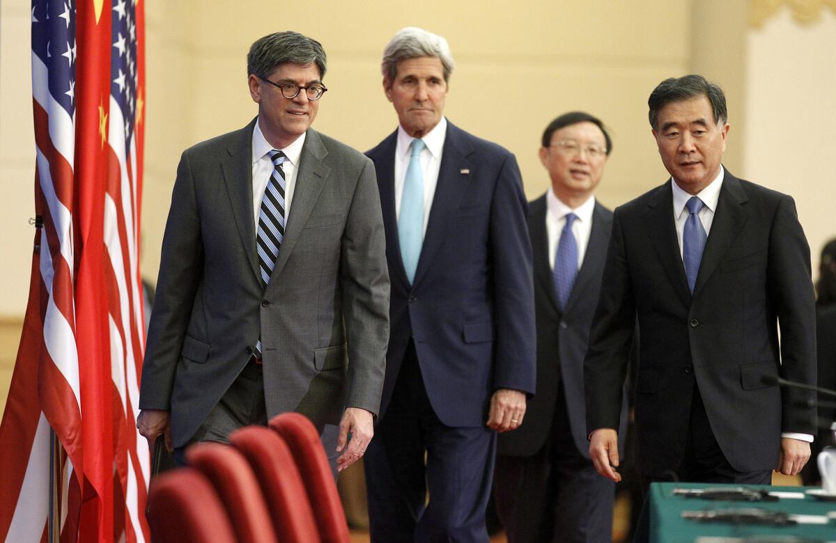 From left, U.S. Treasury Secretary Jack Lew, Secretary of State John F. Kerry, China's State Councilor Yang Jiechi and Vice Premier Wang Yang arrive to deliver statements at the Great Hall of the People in Beijing.