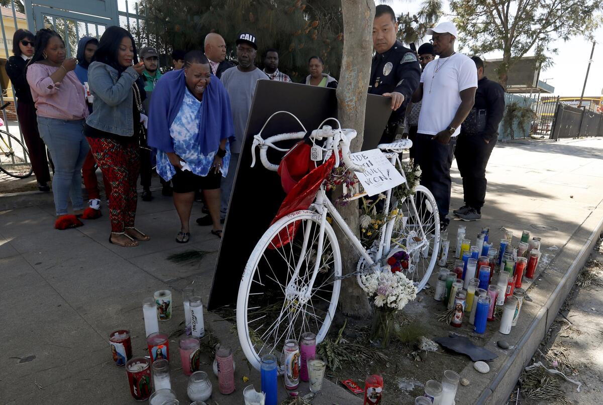 Beverly Owens, the mother of bicyclist Frederick Frazier, is overcome with emotion as she visits the site of the hit-and-run incident that killed her 22-year-old son.