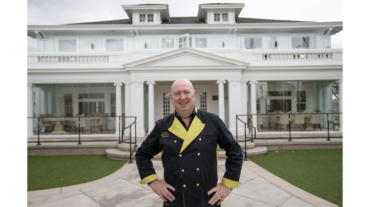 Bruno Serato shows off the exterior of the renovated Anaheim White House restaurant on May 2.