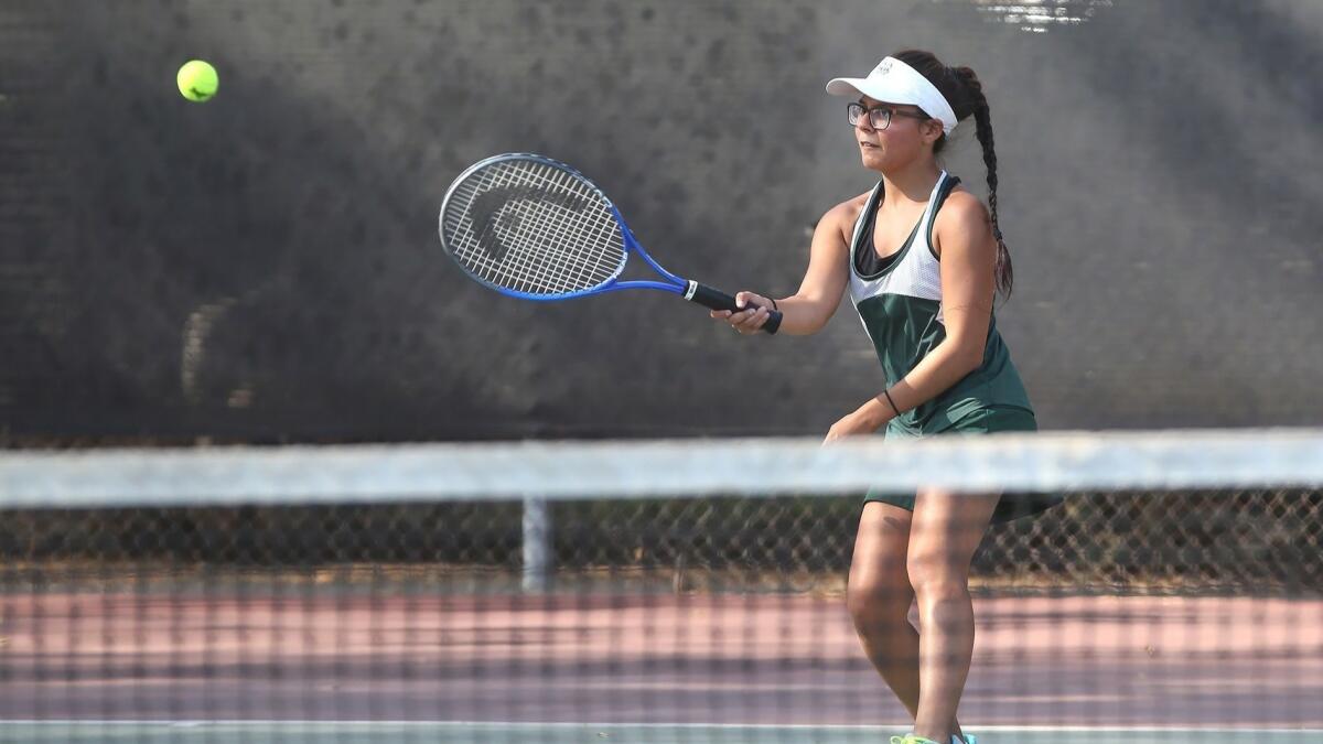 Costa Mesa High's Leslie Delgado, pictured hitting a forehand against Calvary Chapel on Sept. 25, helped the Mustangs beat Saddleback on Tuesday to clinch their first league title since 2002.