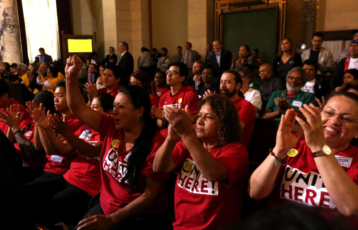 Supporters applaud after the Los Angeles City Council tentatively agreed Tuesday to raise the city’s minimum wage to $15 per hour.