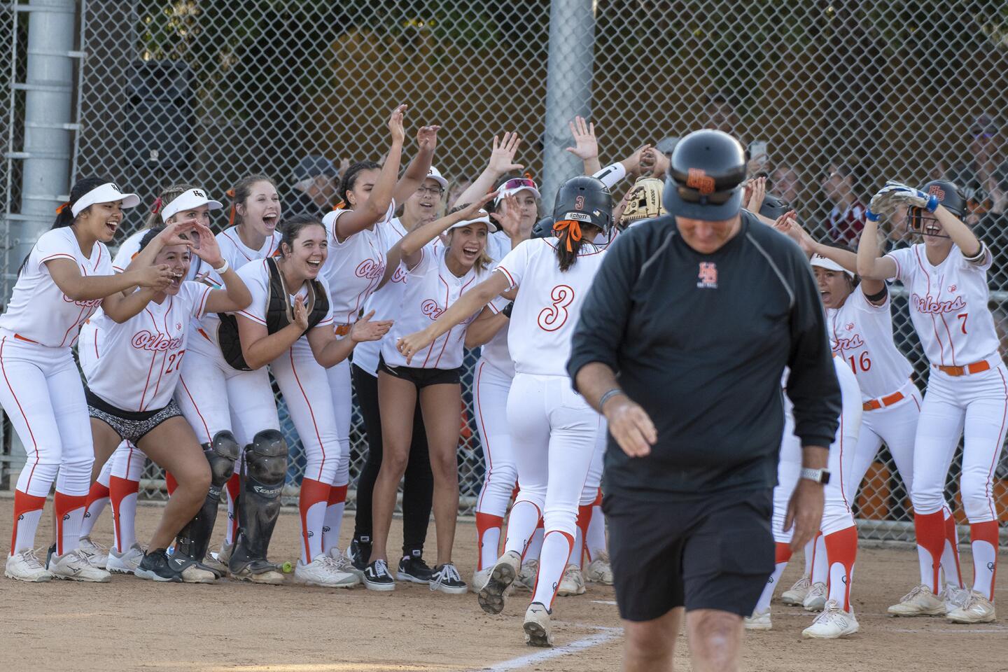 Huntington Beach High's Katelyn Mangrello is greeted at home after hitting a three-run home run in the third inning of a CIF Southern Section Division 1 second-round playoff game against Esperanza at home on Tuesday.