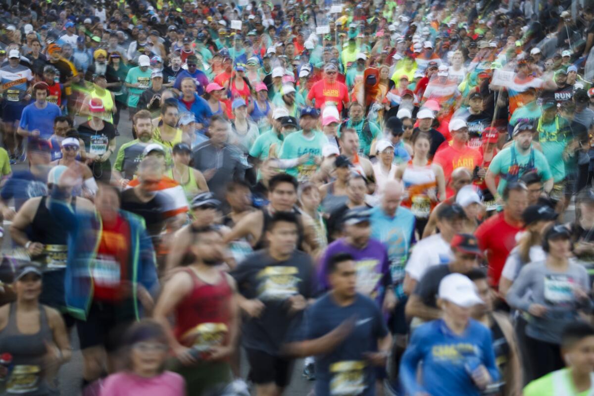 Runners start the 34th annual L.A. Marathon at Dodger Stadium on Sunday in Los Angeles.