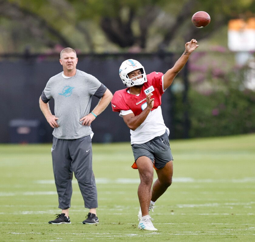 Miami Dolphins Dolphins quarterbacks coach Charlie Frye looks on as Dolphins quarterback Tua Tagovailoa (1) throws a pass during NFL Football practice at Baptist Health Training Complex in Hard Rock Stadium on Wednesday, Dec. 15, 2021 in Miami Gardens, Fla., in preparation for their game against the New York Jets on Sunday. (David Santiago /Miami Herald via AP)