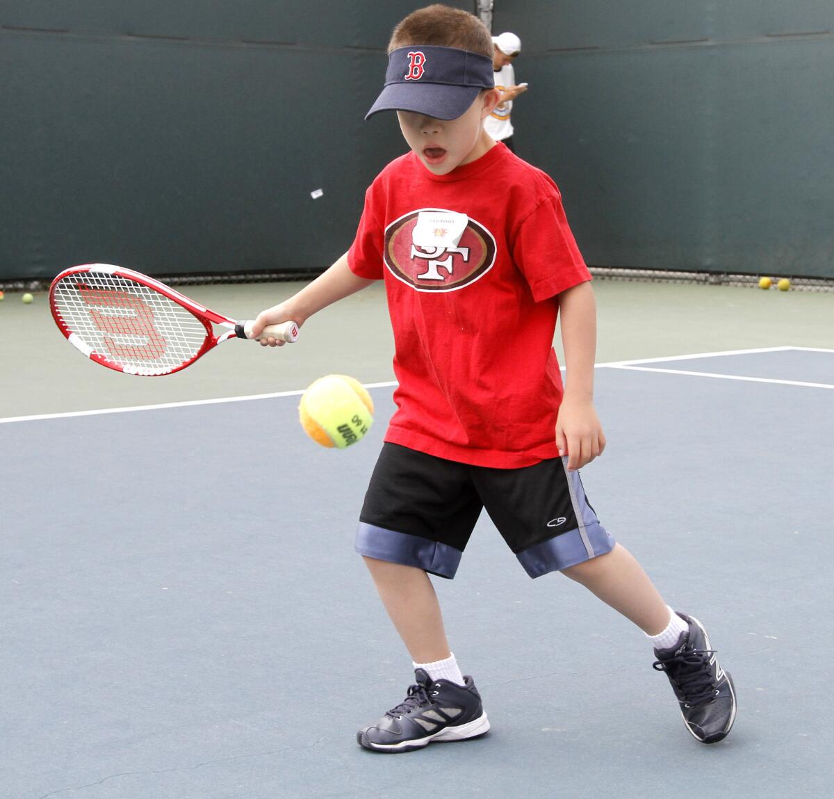 Eight-year old Lukas Hansen plays tennis during the annual Jensen-Schmidt Tennis Academy for Special Needs Individuals at the Burbank Tennis Center in Burbank on Wednesday, June 25, 2014.
