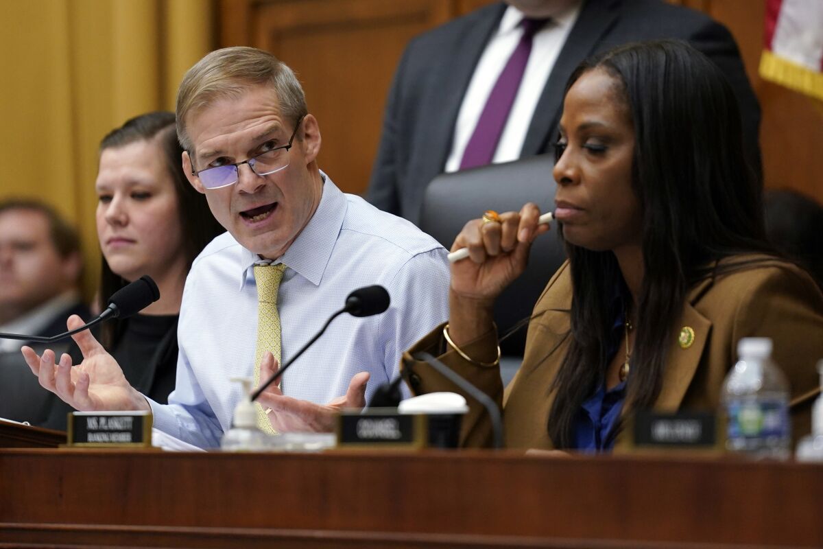 Chairman Jim Jordan speaks as Stacey Plaskett listens during a House subcommittee hearing.
