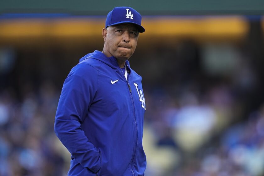 Los Angeles Dodgers manager Dave Roberts walks off the mound after relieving Los Angeles Dodgers.