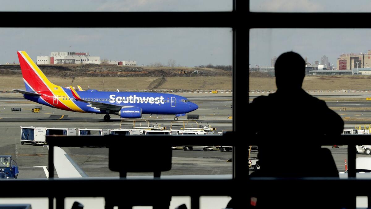 A Southwest Airlines jet taxis at LaGuardia Airport in New York. Southwest's CEO accuses mechanics of grounding planes for minor problems to gain leverage in labor negotiations, a claim the union denies.