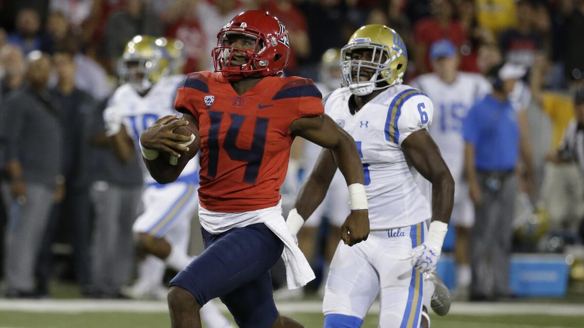 UCLA defensive back Adarius Pickett gives chase as Arizona quarterback Khalil Tate breaks free for a touchdown run Saturday. Tate rushed for 230 yards rushing and two touchdowns.