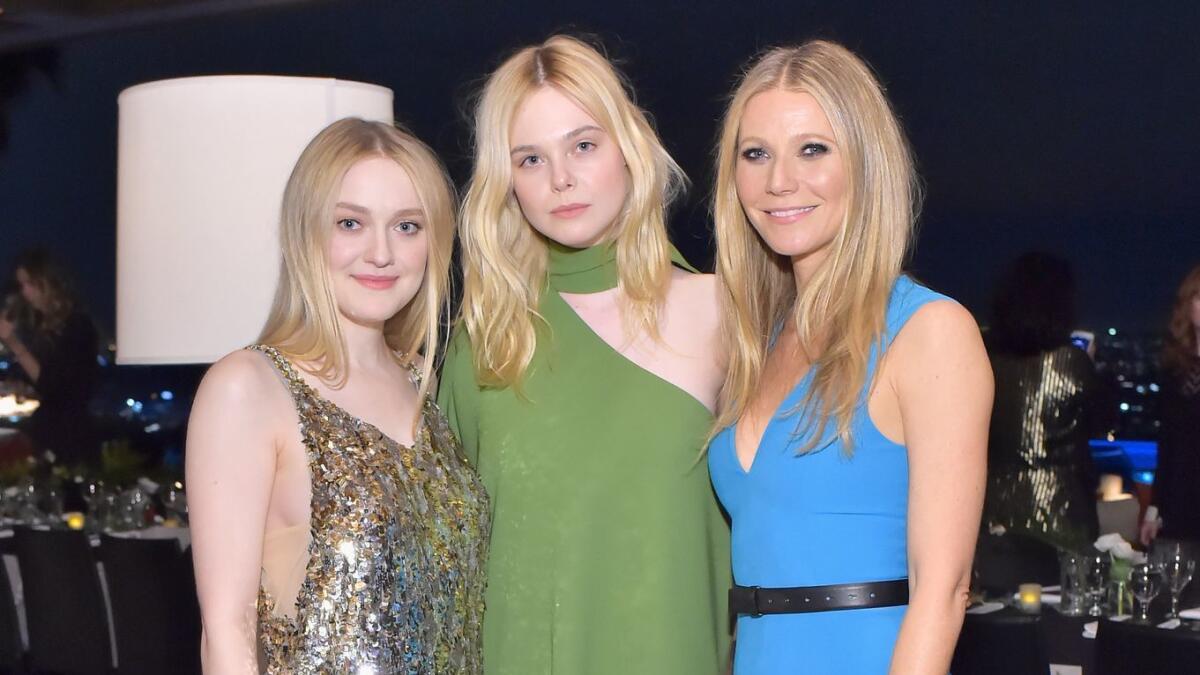 Dakota Fanning, from left, Elle Fanning and Gwyneth Paltrow attend the Hollywood Reporter and Jimmy Choo's power stylists dinner in Los Angeles.