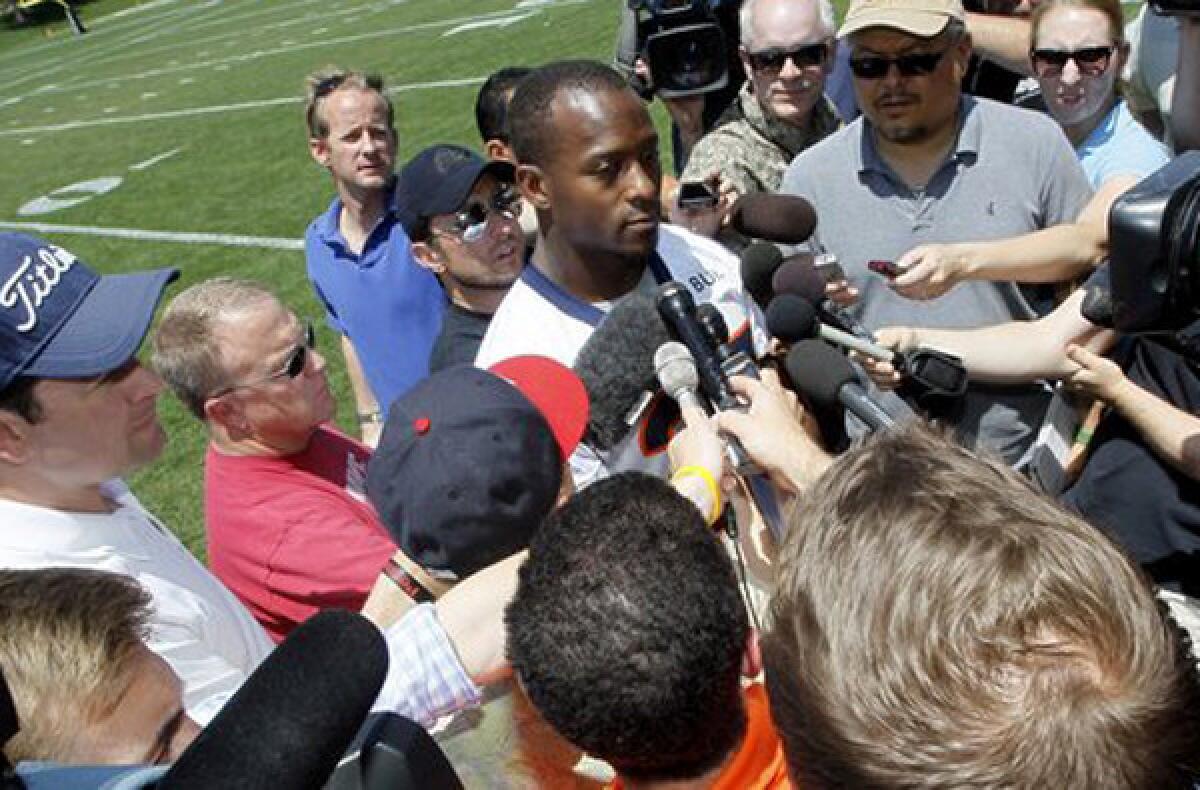 Running back Willis McGahee talks with reporters after Denver's mandatory mini-camp in June, two days before being released by the team.