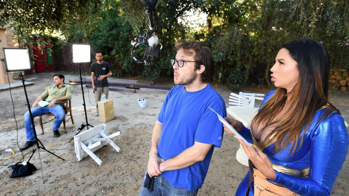 Director/producer Justin Dittrich tests a virtual reality camera as actress Missy Martinez waits on the set of a porn production in Woodland Hills.