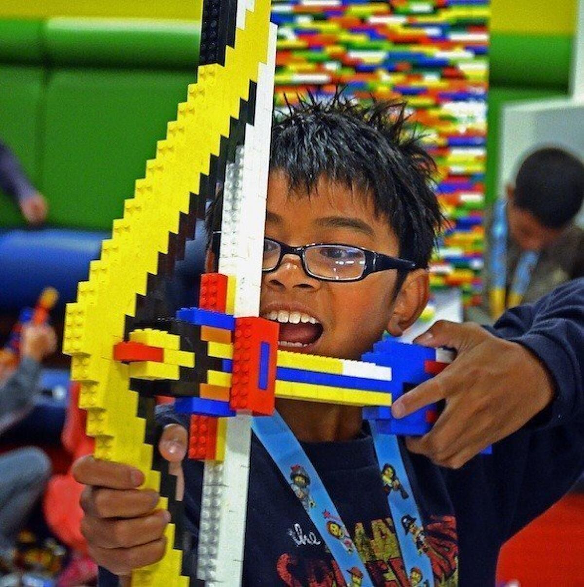 Mason Eugenio, 11, plays with a bow he crafted from Legos at Legoland California in Carlsbad.