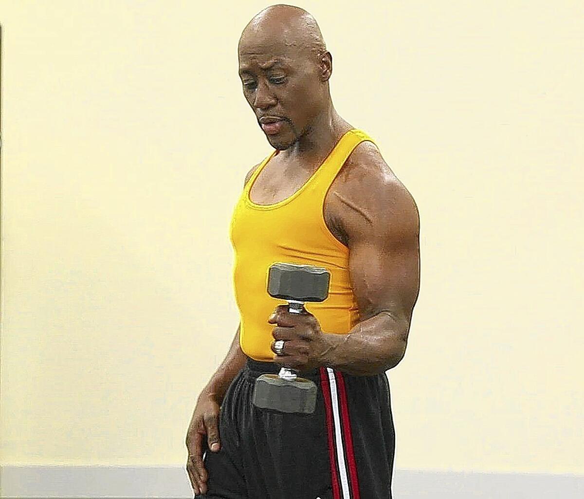 Dr. Levi Harrison demonstrates the rotator cuff exercise with dumbbell.
