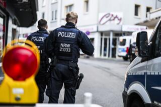 Police officers stand at a cordon in the city center in the early mornin