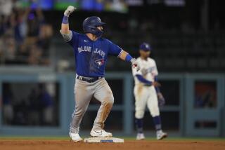 Toronto Blue Jays' Daulton Varsho celebrates after driving in two-runs with a bases-loaded double during the 11th inning of a baseball game against the Los Angeles Dodgers Monday, July 24, 2023, in Los Angeles. (AP Photo/Marcio Jose Sanchez)