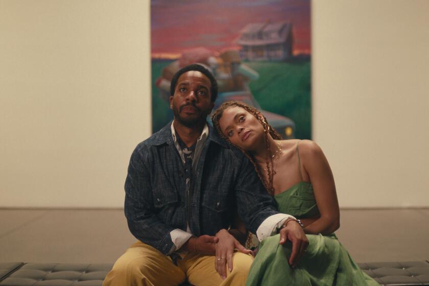 A painter and his wife sit in a gallery.