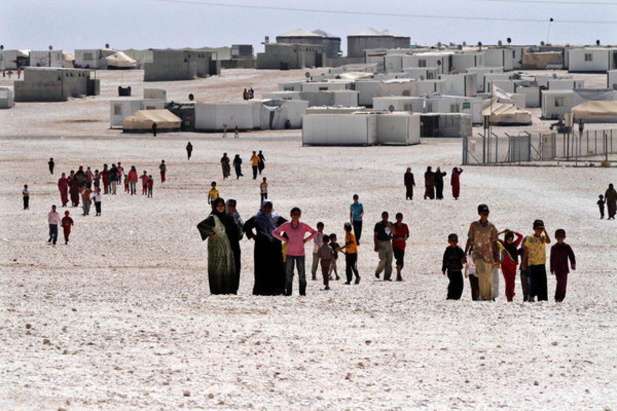 Syrian refugees gather at Za'atari camp in Jordan near the Syrian border in late July.