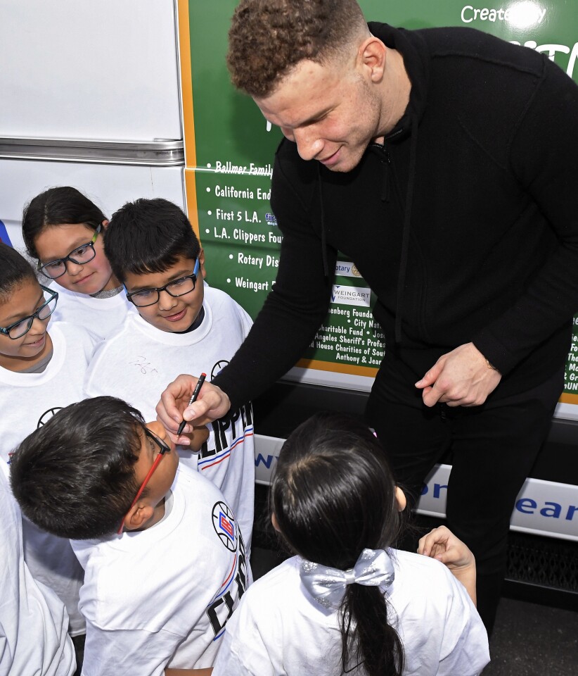 Los Angeles Clippers' Blake Griffin signs autographs for kids after giving them new glasses at Lovelia P. Flournoy Elementary School, Tuesday, Jan. 16, 2018, in the Nickerson Gardens area of Los Angeles, where the Clippers announced a partnership with Vision to Learn and the Los Angeles Unified School District to provide students with eyeglasses. Over 600,000 students will benefit from the program. (AP Photo/Mark J. Terrill)