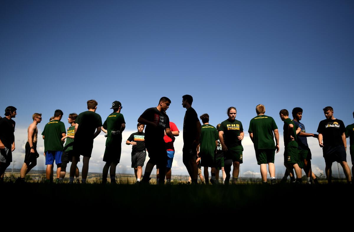 Paradise High School football players run drills during practice at Marsh Junior High School in Chico.