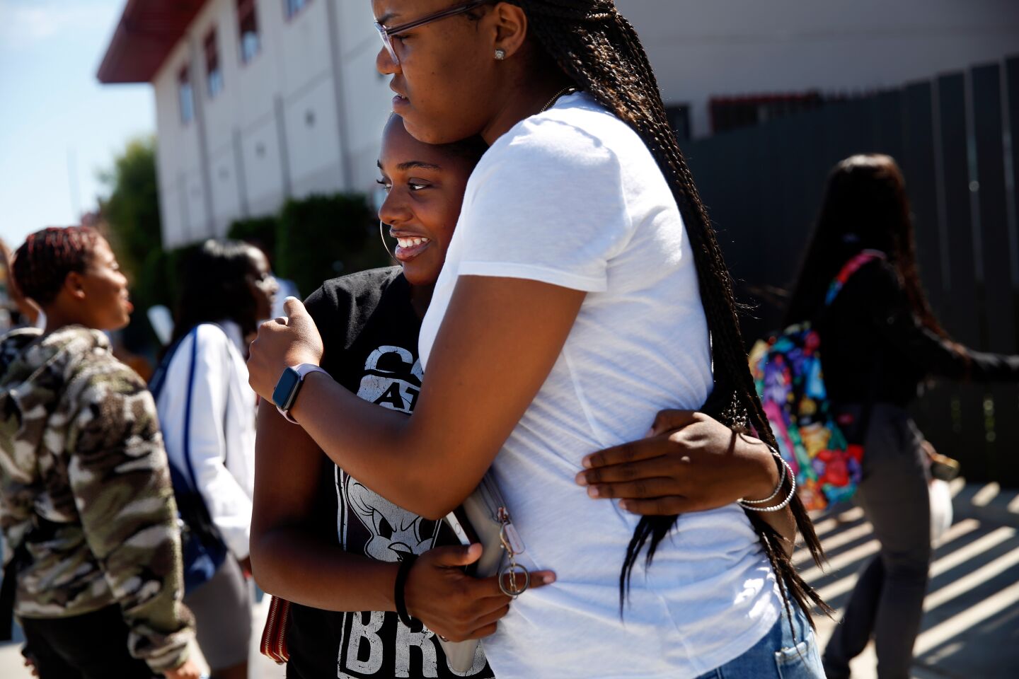Kamryn Johnson hugs alumna Jahvae Lewis after school