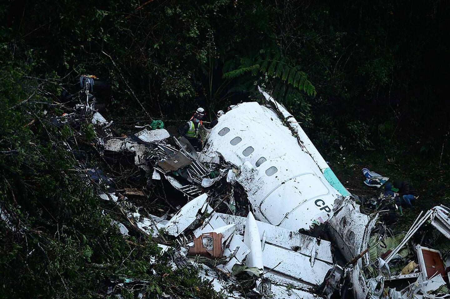 Rescuers search for survivors from the wreckage of the LAMIA airlines charter plane carrying members of the Chapecoense Real football team that crashed in the mountains of Colombia on Nov. 29, 2016.