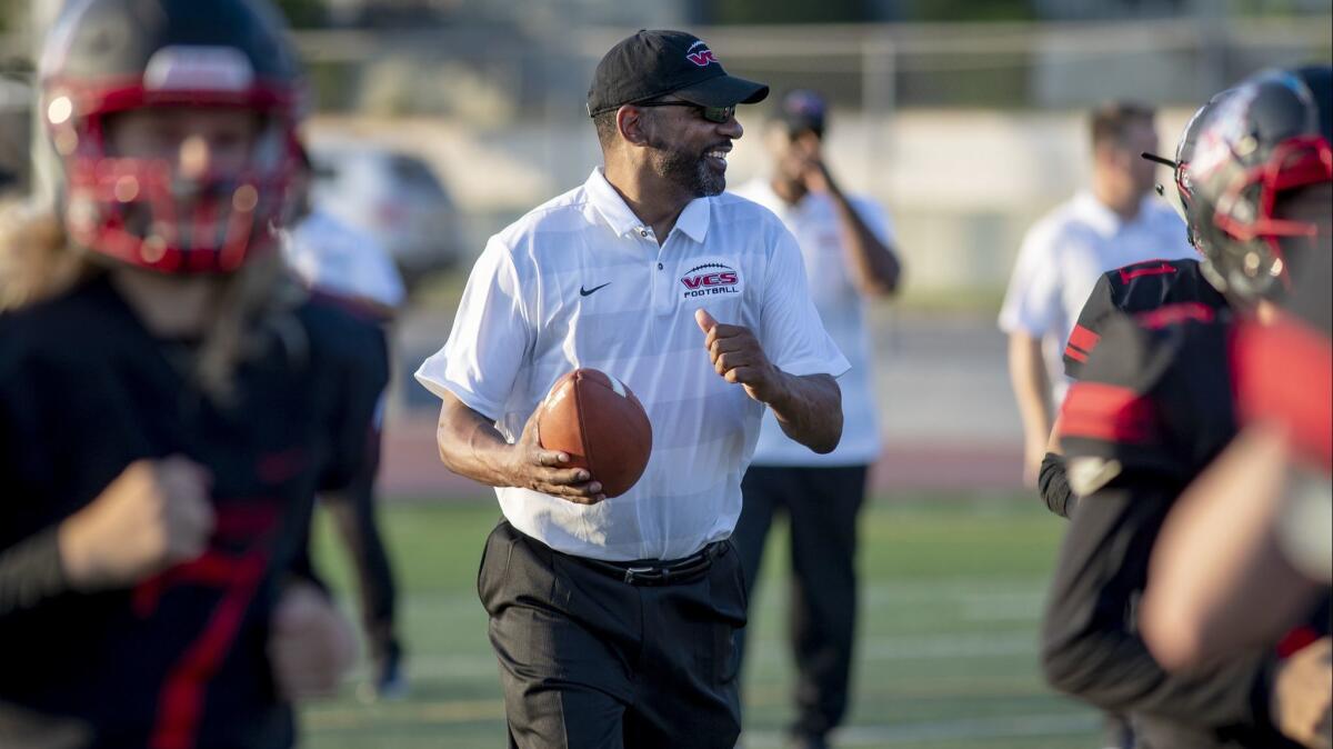 Village Christian offensive line coach Todd McNair on the field in Burbank on Friday.