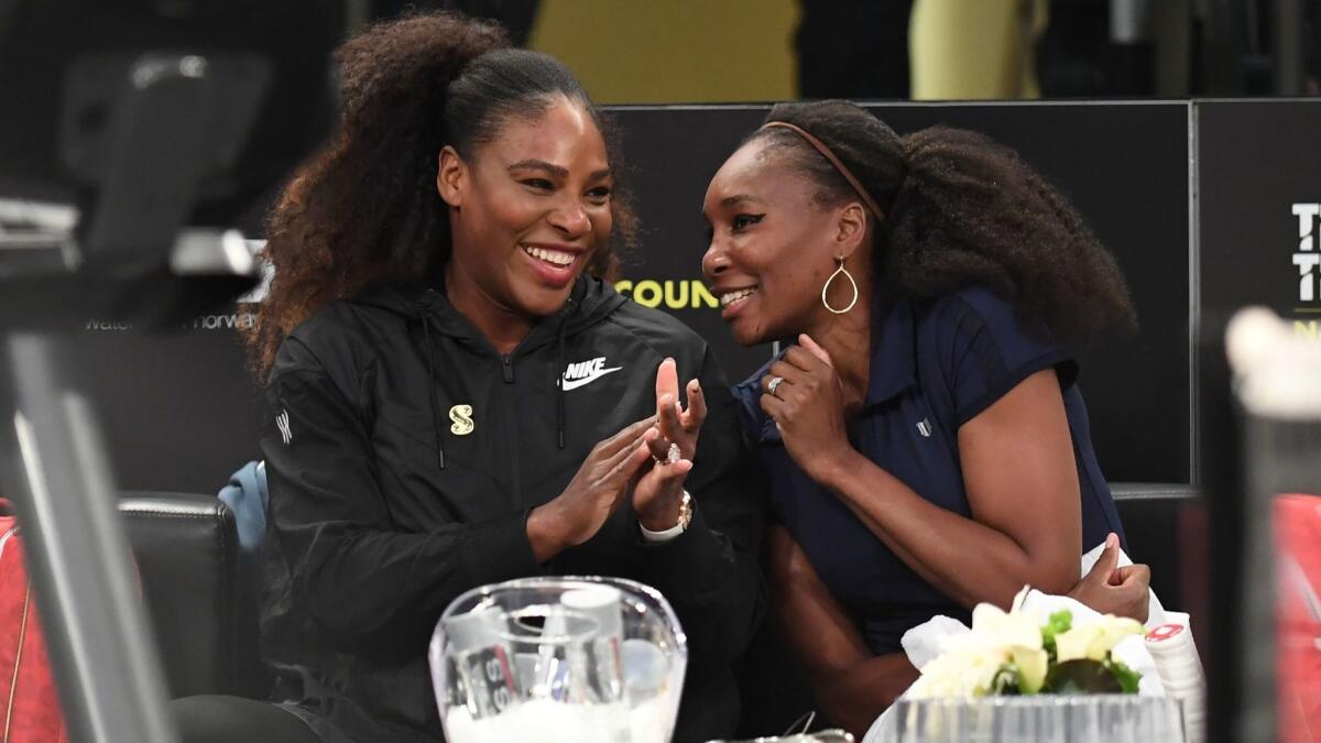 Serena Williams, left, speaks with her sister Venus WIlliams before their matches in a New York tournament on March 5.