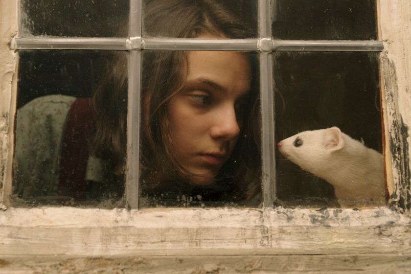 Lyra Belacqua (Dafne Keen) shares a moment with her spirit animal, Pan (Kit Connor), in HBO's adaptation of Philip Pullman's "His Dark Materials."